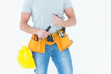 Worker holding hammer over white background
