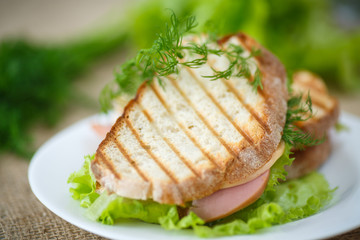 sandwich with sausage, cheese and herbs