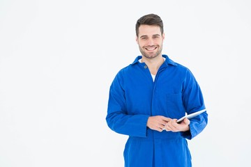 Happy young male mechanic using digital tablet