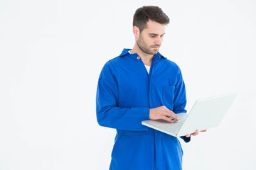 Male mechanic using laptop