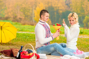 male 35 years, presents a bouquet of his beloved at the picnic