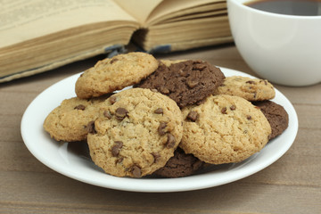 chocolate chip cookies on a plate and coffee with a book