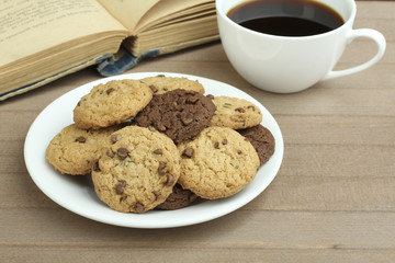 chocolate chip cookies on a plate and coffee with a book