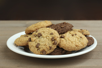 chocolate chip cookies on a plate on a wooden background