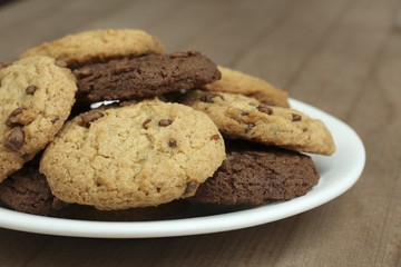chocolate chip cookies on a plate on a wooden background