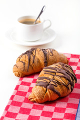 Breakfast with coffee and croissants on table