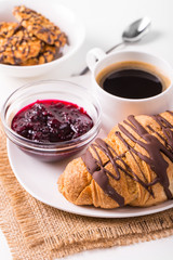 Breakfast with coffee and croissants on table