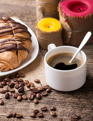 Breakfast with coffee and croissants on wooden table