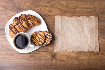 Cappuccino and croissant on wooden table