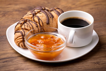 Breakfast with coffee and croissants on table