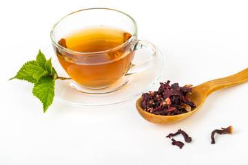 Fresh green, red, black tea leaves in big wooden spoon on white