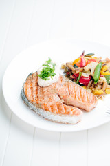 Grilled Salmon with Fresh vegetables on white background