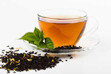 Glass Cup Tea with camomile flower and Mint Leaf, on white