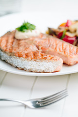 Grilled Salmon with Fresh vegetables on white background