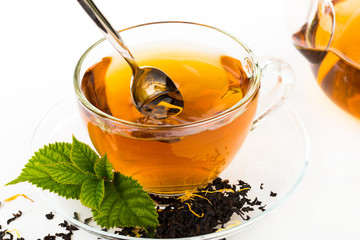 Glass Cup Tea with camomile flower and Mint Leaf, on white backg