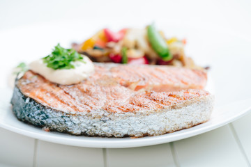Grilled Salmon with Fresh vegetables on white background