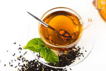 Glass Cup Tea with camomile flower and Mint Leaf, on white backg