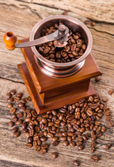 coffee beans and old coffee mill in shop, cafe on wooden table