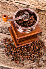 coffee beans and old coffee mill in shop, cafe on wooden table