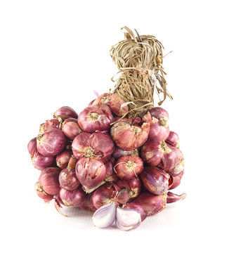 Bunch of fresh shallots on white