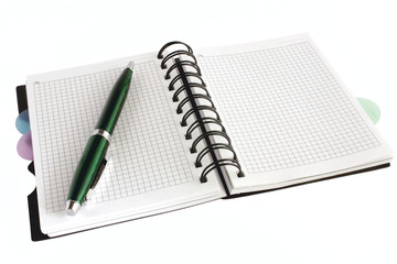 Open notebook with green pen