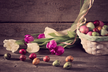 Fototapeta na wymiar tulips and easter eggs on wooden background