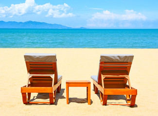 Fototapeta na wymiar Chairs on the beach near sea
