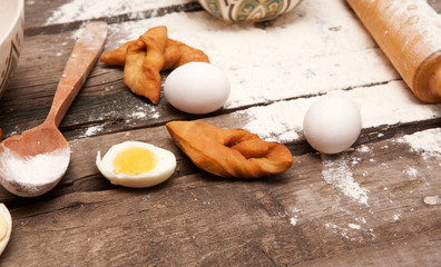 Baking, eggs, flour, plunger in rural kitchen  on wood table