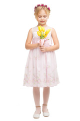 Beautiful little girl with bouquet of yellow tulips