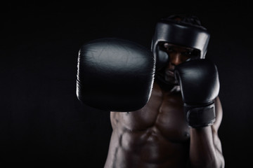 Young muscular man practicing boxing