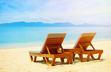 Fototapeta na wymiar Chairs on the beautiful sandy beach near sea
