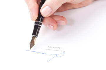 Weibliche Hand unterzeichnet ein Blatt