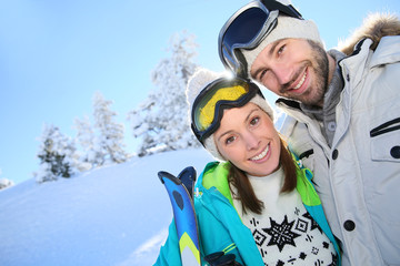 Portrait of cheerful couple in snowy mountain