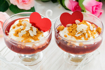 portioned dessert with berry jam and cream for Valentine's Day