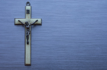 religious christian cross on brushed metal background