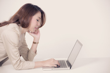Portrait of a young business woman using laptop at office