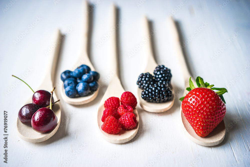 Wall mural Berries on wooden background