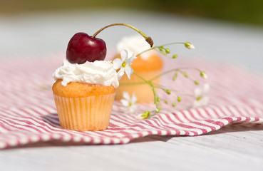 Cupcakes with whipped cream and cherry