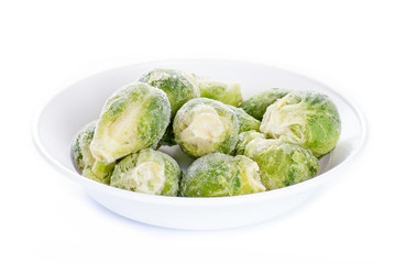 Frozen brussels sprouts on white background
