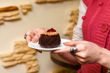 girls hands closeup hold a pastry on a plate