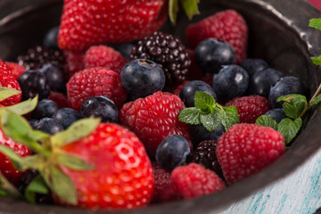 Rustic bowl with fresh summer berries fruits