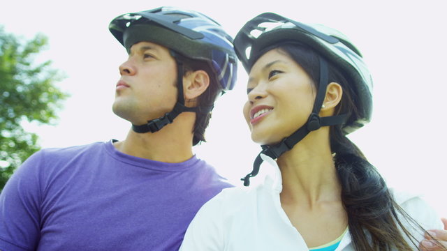 Happy Ethnic Couple Activity Cycling Together Outdoors