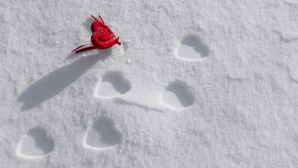 Valentine on snow with heart-shaped steps.