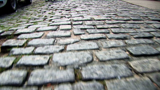 POV walking narrow street cobbles vehicles Rio de Janeiro Brazil 