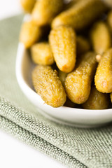 Samll dill pickles in bowl shallow dof close up