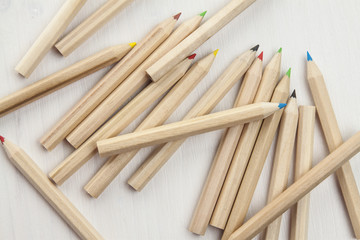 colored pencils on white wooden desk.