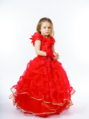 Cute little princess dressed in red dancing. Isolated on white b