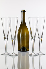 Four  champagne glasses on a glass table
