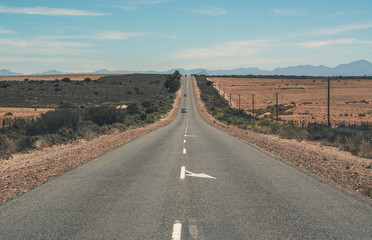 Two cars driving on road in landscape of the Little Karoo. Weste