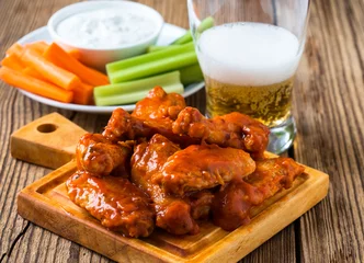 Foto op Canvas Buffalo chicken wing with cayenne pepper  sauce © istetiana